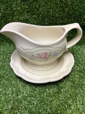 Pfaltzgraff Tea Rose pattern stoneware gravy boat with its underplate.